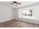 Bedroom with light walls and laminate flooring with a window overlooking the yard at 350 N 88Th St, Mesa, AZ 85207