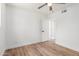 Clean bedroom with a ceiling fan, wood-look flooring and an open door to hall at 350 N 88Th St, Mesa, AZ 85207