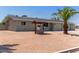 Backyard view of this charming single-story home, featuring decorative well and desert landscaping at 350 N 88Th St, Mesa, AZ 85207