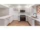 Eat-in kitchen featuring white cabinets, stone countertops and stainless steel appliances at 350 N 88Th St, Mesa, AZ 85207