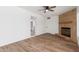 Open concept living room featuring laminate floors and a fireplace with white walls and sliding glass door at 350 N 88Th St, Mesa, AZ 85207