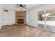 Spacious living room features updated floors, a brick fireplace and sliding glass door access to the backyard at 350 N 88Th St, Mesa, AZ 85207