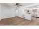 Open-concept living area showcasing wood-look floors, white walls and a breakfast bar overlooking the kitchen at 350 N 88Th St, Mesa, AZ 85207