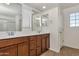 Bright bathroom with double sink vanity, framed mirrors, and a shower-tub combination at 3535 E Erie St, Gilbert, AZ 85295