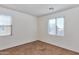 Neutral bedroom with carpet, two windows, and ample natural light at 3535 E Erie St, Gilbert, AZ 85295