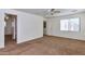 Spacious bedroom with carpet, ceiling fan, natural light, and access to closet and ensuite bathroom at 3535 E Erie St, Gilbert, AZ 85295