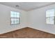 Neutral bedroom with carpet, two windows, and ample natural light at 3535 E Erie St, Gilbert, AZ 85295