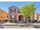 Charming two-story home featuring a well-maintained front yard with tasteful landscaping and neutral color palette at 3535 E Erie St, Gilbert, AZ 85295