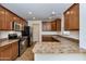 Well-equipped kitchen with stainless steel appliances and ample counter space featuring warm toned cabinets at 3535 E Erie St, Gilbert, AZ 85295