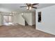 Spacious living room features neutral colored carpet, bright natural light, and modern ceiling fan at 3535 E Erie St, Gilbert, AZ 85295