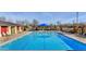 Enjoy the community pool with a splash pad, lounge chairs, and shaded seating areas at 3535 E Erie St, Gilbert, AZ 85295