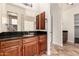 Bathroom with granite countertops, rich wood cabinetry, and a view into the shower area at 3715 S Skyline Dr, Gilbert, AZ 85297