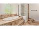 Relaxing primary bathroom features a soaking tub and a separate glass block shower at 3715 S Skyline Dr, Gilbert, AZ 85297