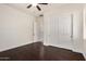 Bedroom with hardwood floors and closet with white bi-fold doors at 3715 S Skyline Dr, Gilbert, AZ 85297