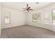 Bright and airy bedroom with neutral carpet, multiple windows, and a ceiling fan at 3715 S Skyline Dr, Gilbert, AZ 85297