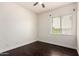 Bright bedroom featuring laminate floors, ceiling fan and a sunlit window for natural lighting at 3715 S Skyline Dr, Gilbert, AZ 85297