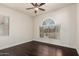 Bright bedroom with hardwood floors, ceiling fan, and large window at 3715 S Skyline Dr, Gilbert, AZ 85297