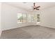 Carpeted bedroom featuring ample natural light from several windows and access to the outdoors at 3715 S Skyline Dr, Gilbert, AZ 85297