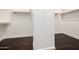 Walk-in closet with built-in shelving and dark wood flooring offering ample storage space at 3715 S Skyline Dr, Gilbert, AZ 85297