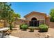 A single-story home with desert landscaping, stone accents, and an arched front window at 3715 S Skyline Dr, Gilbert, AZ 85297