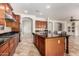 Well-equipped kitchen boasting a center island, dark countertops, and stainless steel appliances at 3715 S Skyline Dr, Gilbert, AZ 85297