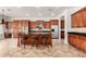 Gourmet kitchen with wood cabinetry, granite countertops, and a large center island with seating at 3715 S Skyline Dr, Gilbert, AZ 85297