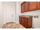 Laundry room features wood cabinets, tile floor and utility sink at 3715 S Skyline Dr, Gilbert, AZ 85297