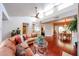 Open-concept living room flowing into dining area, featuring vaulted ceiling and hardwood floors at 37222 N Tom Darlington Dr # 15, Carefree, AZ 85377