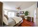 Cozy main bedroom with a king-size bed, ceiling fan, and a dresser with a mounted television at 37222 N Tom Darlington Dr # 15, Carefree, AZ 85377