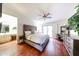 Comfortable main bedroom with a king-size bed, ceiling fan, and sliding glass door to the backyard at 37222 N Tom Darlington Dr # 15, Carefree, AZ 85377