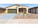 Charming single-story home featuring a stucco exterior, covered entryway, two-car garage, and low maintenance desert landscaping at 37582 W San Clemente St, Maricopa, AZ 85138