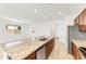 Open kitchen features a large island with granite countertops, stainless steel appliances, and ample cabinet space at 37582 W San Clemente St, Maricopa, AZ 85138