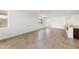 Spacious living area with tile floors, bright windows, and a kitchen island, perfect for modern living at 37582 W San Clemente St, Maricopa, AZ 85138