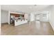 Open-concept living space features tile flooring, abundant natural light, and seamless flow to the kitchen at 37582 W San Clemente St, Maricopa, AZ 85138