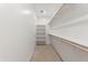 Spacious walk-in closet with shelving and clothing rods, providing ample storage for clothes and accessories at 37582 W San Clemente St, Maricopa, AZ 85138