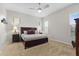 Neutral bedroom features a ceiling fan, large window, and carpet flooring at 3865 E Dogwood Pl, Chandler, AZ 85286