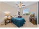 Cozy bedroom with ceiling fan, large window, and comfortable blue bedding at 3865 E Dogwood Pl, Chandler, AZ 85286