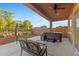 Inviting covered patio area with a hot tub, ceiling fan, and comfortable seating, perfect for relaxation at 3865 E Dogwood Pl, Chandler, AZ 85286