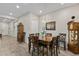 Elegant dining room with a wooden table set, chandelier, and decorative mirror at 3865 E Dogwood Pl, Chandler, AZ 85286
