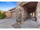 Covered front porch featuring stone-accented column and seating area, offering a charming entrance to the home at 3865 E Dogwood Pl, Chandler, AZ 85286
