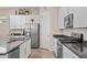 Kitchen with white cabinets, stainless steel appliances, and granite countertops at 3865 E Dogwood Pl, Chandler, AZ 85286