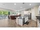 Open-concept kitchen with stainless steel appliances and adjacent living area with sliding glass door at 3865 E Dogwood Pl, Chandler, AZ 85286