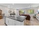 Modern kitchen island featuring stainless steel sink and fixtures with open access to living room at 3865 E Dogwood Pl, Chandler, AZ 85286