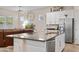 Modern kitchen with granite counters, stainless steel appliances, and a view into the living room at 3865 E Dogwood Pl, Chandler, AZ 85286