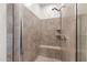 The tiled shower features a built-in seat, a shower head with a handle, and tiled shelves at 3865 E Dogwood Pl, Chandler, AZ 85286