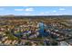 High angle view of a Primary-planned community with homes bordering a network of canals, and views of distant mountains at 42 S Nevada Way, Gilbert, AZ 85233