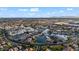 Breathtaking aerial view showcasing a community's picturesque lake, surrounded by beautiful homes and lush greenery at 42 S Nevada Way, Gilbert, AZ 85233