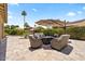 Charming backyard featuring an outdoor patio, inviting seating area, and lush greenery at 42 S Nevada Way, Gilbert, AZ 85233