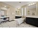 A modern bathroom with dual vanities, a freestanding tub, and black and white tiling at 42 S Nevada Way, Gilbert, AZ 85233