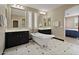 The well-lit bathroom boasts double sinks, mirrors and a modern standalone tub at 42 S Nevada Way, Gilbert, AZ 85233